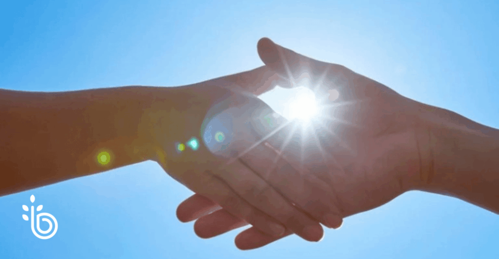Hands shaking with the sun in the background indicating the beginning of a new financial planning relationship