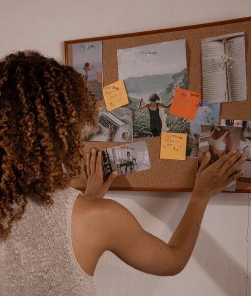 A women using a vision board as motivation to accomplish her financial goals