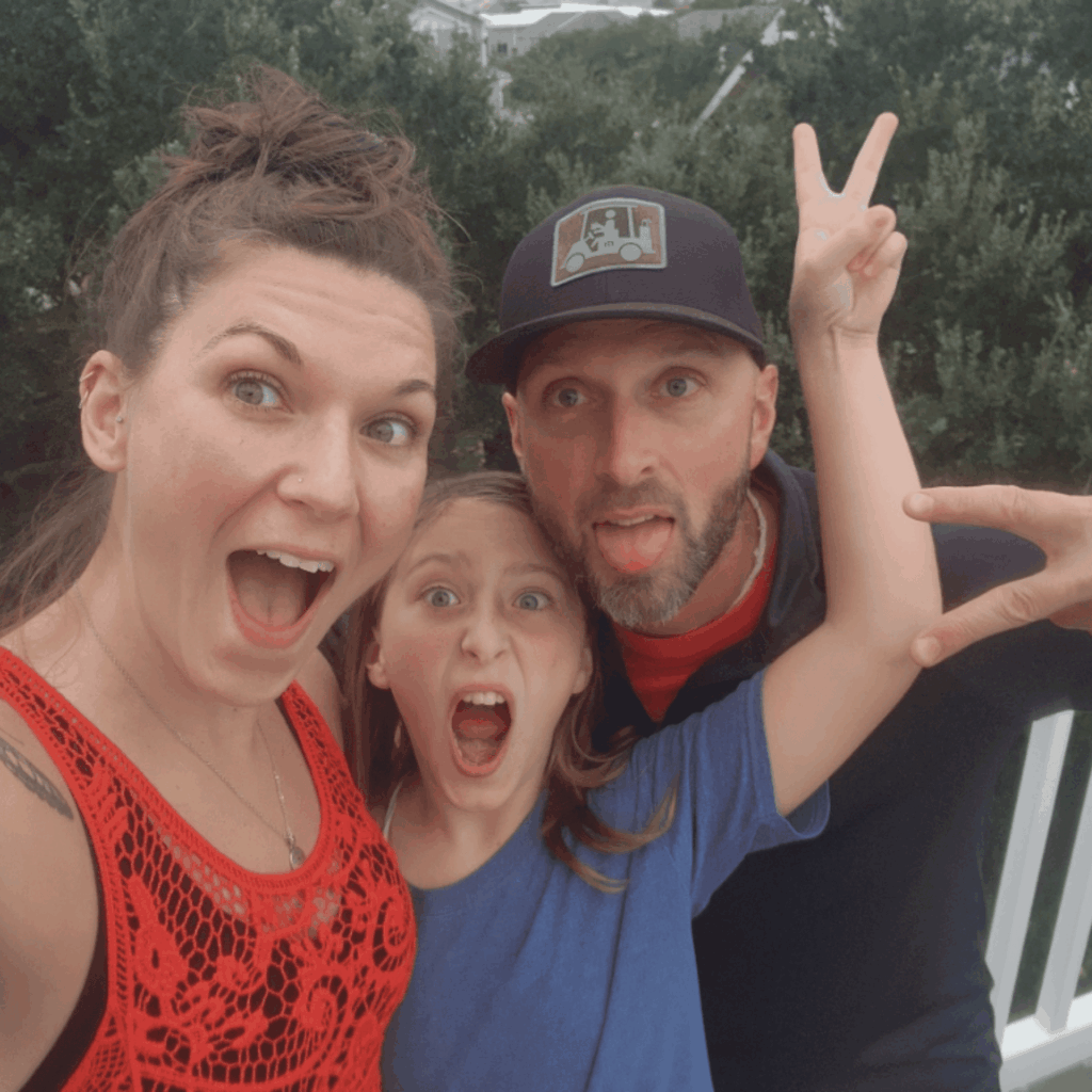 Kassi Redifer sharing a playful moment with her husband and daughter during a family vacation in North Carolina.